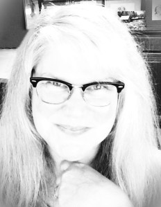 woman with white hair wearing glasses